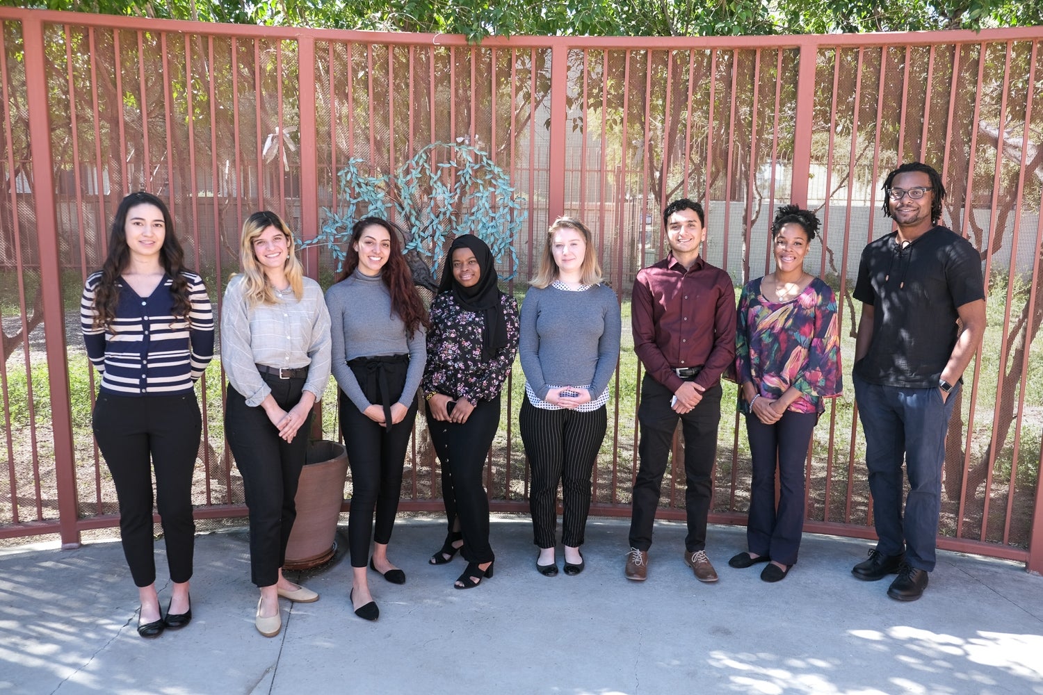 Members of Public Allies Arizona's first Tucson class stand in front of a gate outside.