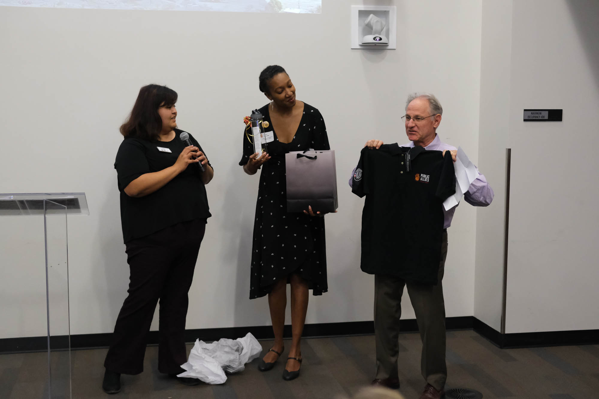 Two Public Allies Arizona alumni present a gift to Tucson Mayor Jonathan Rothschild.