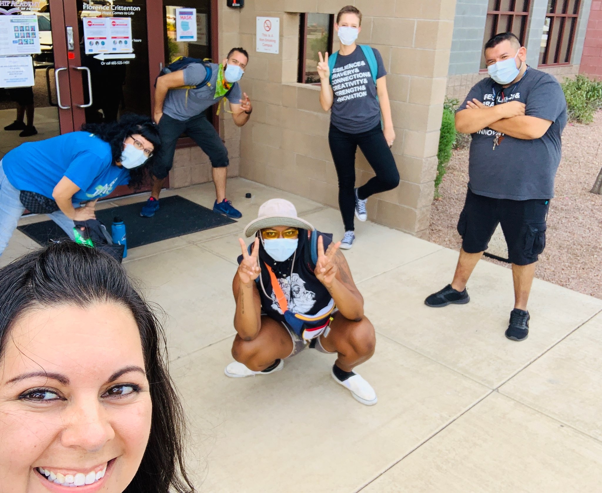 Members of Free Arts for Abused Kids of Arizona in front of a building. All are wearing face masks.