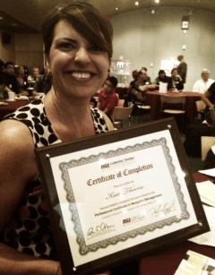 Kate Thoene poses with a certificate.