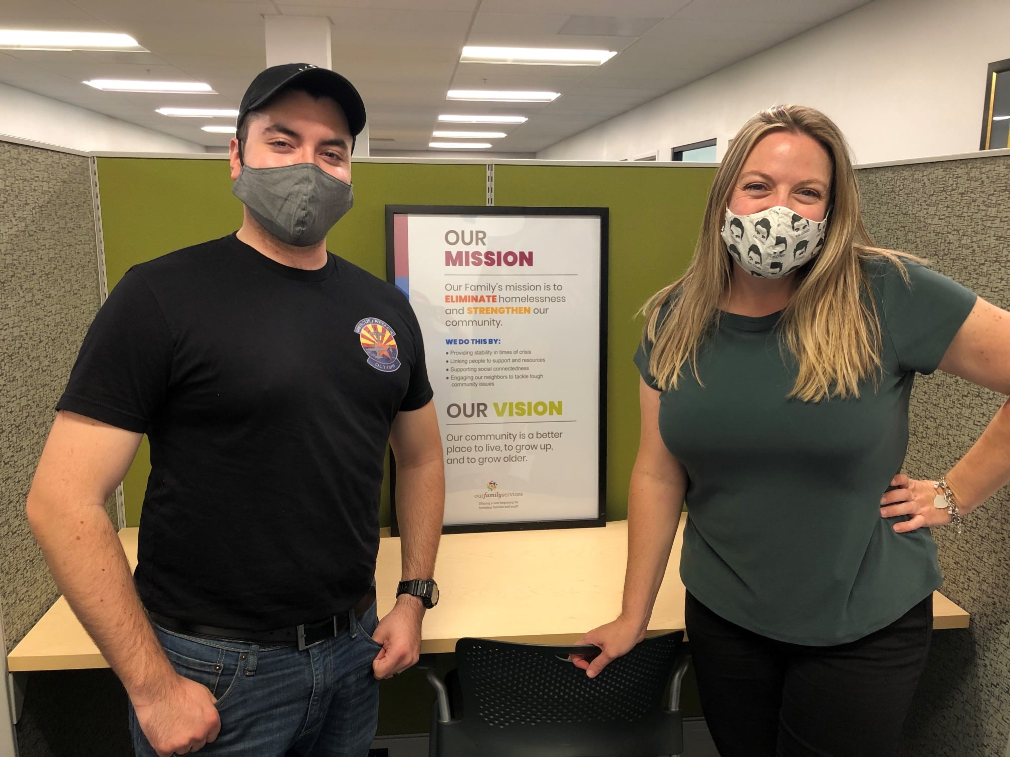 Staff Sergeant Javier Ortega and Our Family Services Grant Writer Sarah McNamara smile at the camera. Both are wearing face masks.